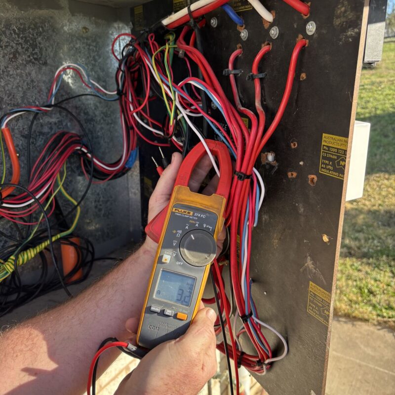 Calwinn Electrical electrician diagnosing a wiring fault with a clamp meter in the Upper Hunter Shire